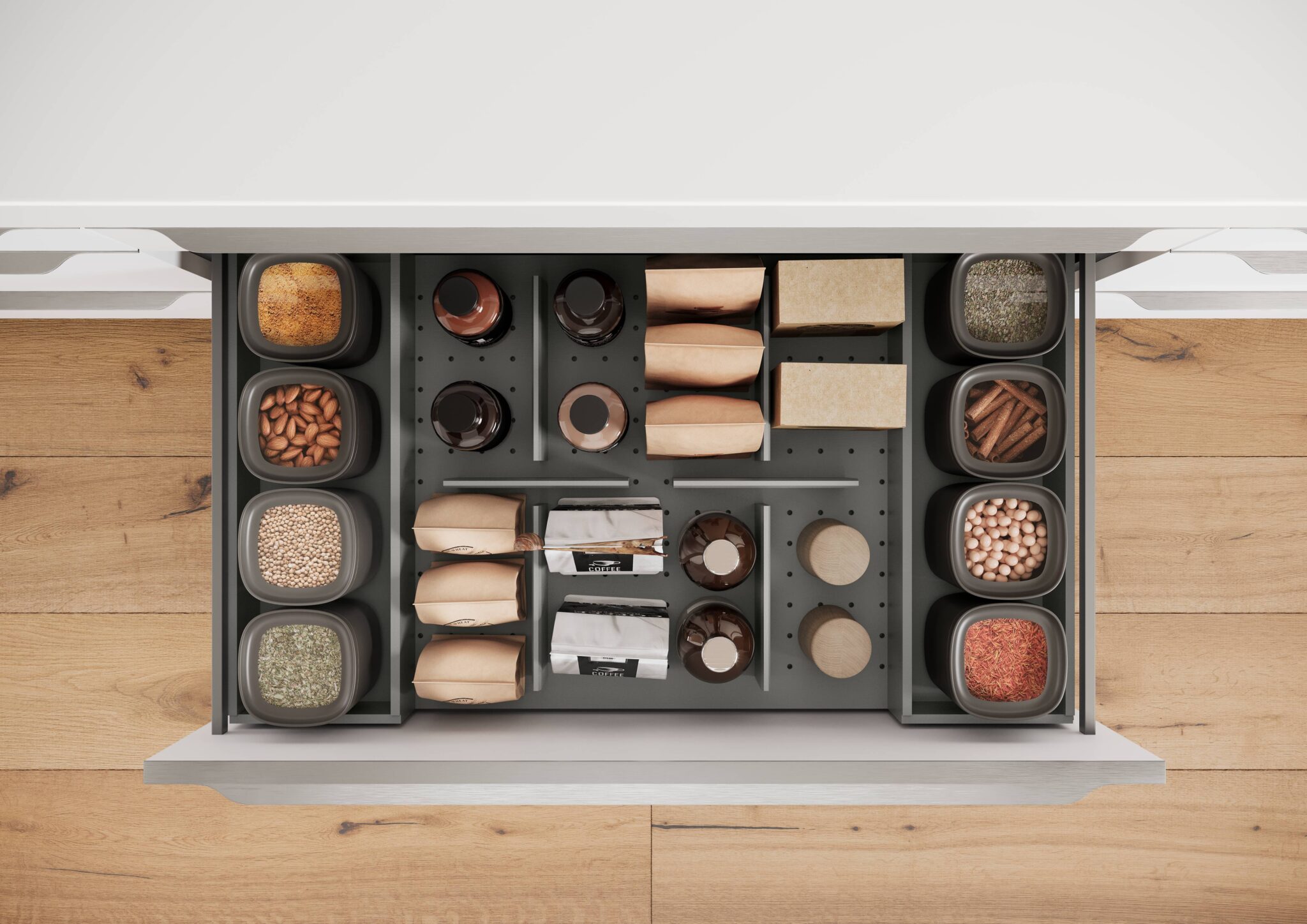 Tiroir de cuisine ouvert avec des bocaux gris contenant des épices et des graines, et des paquets en papier brun alignés.